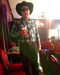 Me dressed as a cowboy, holding a beer